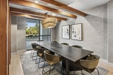 Step into a world where work feels effortless. This sophisticated 820 sq ft suite blends contemporary design with warm, natural elements — exposed wood beams, light hardwood floors, and floor-to-ceiling windows that bathe every corner in natural light. The open lounge area, anchored by a sculptural pendant light and sleek banquette seating, sets the tone for inspired collaboration. Private glass-walled rooms offer serene, tree-lined views, creating a tranquil retreat for focused work. Every detail, from curated artwork to artisan lighting, speaks to an elevated standard of professional living.