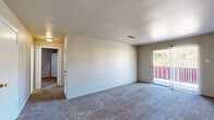 This 2-bedroom, 2-bathroom single-floor residence at 2000 Parkway Dr in North Little Rock, Arkansas offers a practical and well-organized layout. The living room is generously sized, featuring neutral carpet flooring, light-toned walls, and a sliding glass door that opens to a balcony, providing natural light and outdoor access. Adjacent to the living area is a combined dining and kitchen space. The kitchen is equipped with white cabinetry, granite-look countertops, a coil-top electric range, and a double sink, all complemented by patterned tile flooring. The primary bedroom is a comfortable, carpeted room with two closets providing ample storage. The second bedroom is similarly carpeted and bright, with its own closet. Both bathrooms feature a vanity with granite-look countertops, a large mirror, overhead lighting, and a tub/shower combination with tile flooring. Throughout the unit, storage is a notable highlight, with six closets in total distributed across the bedrooms and hallway. A dedicated utility room adds further functional convenience. The layout connects seamlessly through a central hallway, creating an efficient and cohesive flow throughout the home.