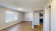 Located at 1300 Ridgefield Ave in Thibodaux, Louisiana, this single-story, 3-bedroom, 2-bathroom home offers a practical and well-organized layout. Wood-look flooring runs consistently throughout the home, lending a cohesive and clean aesthetic to every room. The living room is bright and open, featuring neutral-toned walls, blinds-covered windows that allow natural light, and direct sightlines to both the entry door and the kitchen. The kitchen is efficiently designed with dark gray cabinetry, light granite-look countertops, a gas range, and a double basin sink — providing ample storage and functional workspace. Each of the three bedrooms features wood-look flooring, neutral walls, and windows dressed with blinds for natural light and privacy. The primary bedroom includes a closet with built-in shelving and hanging rods. One bedroom benefits from dual windows, enhancing natural light. The two bathrooms are clean and functional, each featuring wood-look flooring, a white vanity with storage, a mirror, and a tub-shower combination. A hallway connects the bedrooms and bathrooms, contributing to a logical flow throughout the home. Textured ceilings are present in select rooms, adding a traditional touch to the overall interior character.