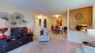 Located at 200 High Ridge Dr in Sanford, NC, this single-floor home offers a well-organized and comfortable layout throughout. The kitchen is equipped with warm honey-toned wood cabinetry, ample counter space, tile flooring, and a full suite of appliances including an electric range and dishwasher, with a pantry closet for additional storage. A pass-through counter connects the kitchen to the adjacent living and dining areas, promoting an open and connected feel. The living room features plush carpet flooring and flows seamlessly into the dining area, which is finished with tile flooring and receives warm ambient lighting. The primary bedroom is generously sized with carpeted floors, large windows, and a relaxed, welcoming atmosphere. A second bedroom, also carpeted, offers a bright and versatile space with a window and closet access. Both bathrooms are finished with tile flooring and wood vanities with white countertops, each featuring a tub-shower combination. The overall interior maintains a consistent warm neutral palette, with light-toned walls throughout, creating a cohesive and inviting living environment across all rooms.