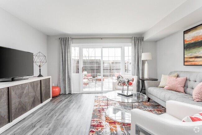 Living Room and Patio - Jamestown at St. Matthews Apartments