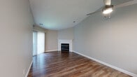 Located at 36200 Dequindre Rd in Sterling Heights, Michigan, this single-floor, two-bedroom, one-bathroom residence offers a practical and comfortable layout across a well-utilized footprint. The open living area is a standout feature, boasting vaulted ceilings with a ceiling fan, rich hardwood-style flooring, and a classic white-mantled fireplace. A sliding glass door floods the space with natural light and provides direct access to a private patio. The kitchen is outfitted with white cabinetry, a white quartz countertop, a subway tile backsplash, stainless steel appliances, and an undermount sink — all illuminated by overhead lighting and a window. A central hallway connects the main living areas to the bedrooms, transitioning from hardwood-style flooring to plush carpet. The primary bedroom is generously sized, featuring neutral tones and ample closet space. The secondary bedroom also offers carpeted floors, a window with natural light, and a dedicated closet. The full bathroom features a soaking tub surrounded by large-format marble-look tile. With five closets throughout, storage is plentiful. The neutral color palette and clean finishes give the space a move-in ready appeal.