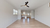 Located at 260 Starling Circle in Oswego, IL, this two-story home offers five bedrooms and five bathrooms across two well-proportioned floors. The main level is the larger of the two, anchored by an open-concept living and kitchen area with light-toned hardwood flooring, crisp white walls, and ceiling fans that enhance the airy feel. The kitchen is well-appointed with white shaker cabinetry, granite countertops, stainless steel appliances including a refrigerator, range, microwave, and dishwasher, plus a central island and pendant lighting. Multiple windows allow generous natural light to fill the space. A staircase connects to the upper level, which hosts additional bedrooms finished with plush carpeting and ample natural light from multiple windows. Two closets provide dedicated storage. The bathrooms feature clean, modern finishes including granite vanity countertops and soaking tubs. The primary bedroom is a comfortable retreat with its own ceiling fan and well-lit closet. Throughout the home, the neutral color palette, consistent flooring materials, and clean architectural lines create a cohesive, move-in-ready environment suited for a variety of living arrangements.