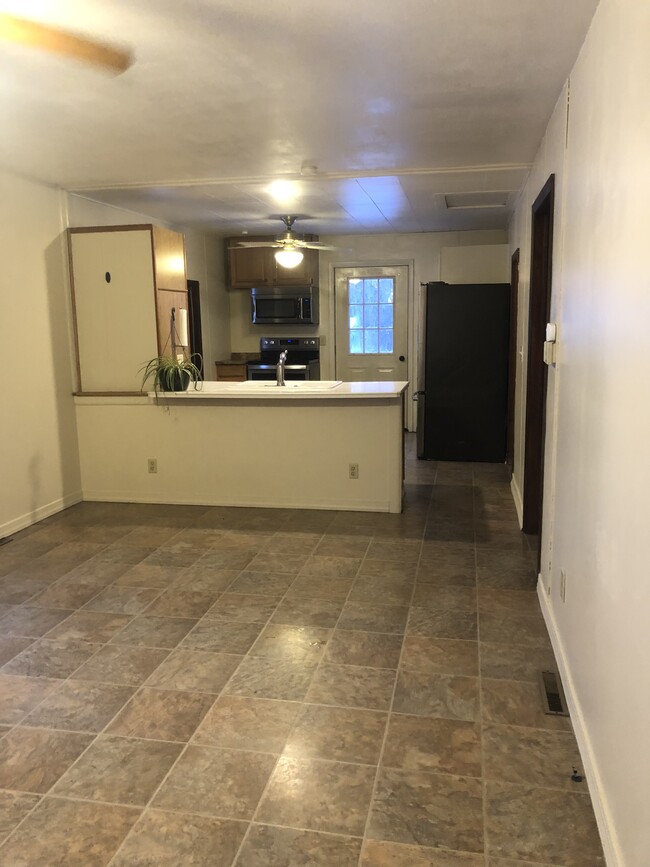 Open concept living room- kitchen Counter overhang for stools - 6764 Sutliff Rd