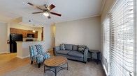 Located at 3220 Hoffmeyer Rd in Florence, SC, this single-floor unit offers a well-designed layout that balances functionality and comfort throughout. The galley-style kitchen is outfitted with rich wood cabinetry, granite-look countertops, hardwood-style flooring, and black appliances including a range, microwave, and refrigerator, providing ample storage and prep space. Adjacent to the kitchen, the dining area features hardwood-style flooring, crown molding, and a classic pendant chandelier, creating an inviting space for meals. The living room is carpeted and appointed with a ceiling fan, crown molding, and a pass-through view into the kitchen, lending an open, connected feel to the common areas. Both bedrooms are carpeted and include ceiling fans and windows that allow natural light to filter in, offering a relaxing retreat. The full bathroom is finished with hardwood-style flooring, a rich wood vanity with a stone-look countertop, a large mirror, and a full tub-shower combination, delivering a clean and practical design. Neutral wall tones and consistent finishes throughout tie the space together into a cohesive, move-in-ready home.