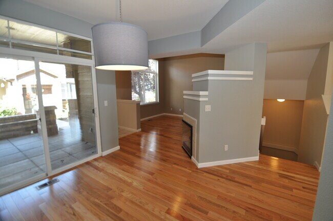 Dining room looking into living room, patio, and stairwell leading to two car garage - 6478 Silver Mesa Drive Unit C