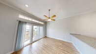 This 610 square foot apartment in Galveston, Texas offers a thoughtful layout within its compact footprint. The single-floor design comprises one spacious 440 square foot bedroom, a full bathroom, and a hallway connecting the spaces. Modern finishes are evident throughout, with light-toned wood-look flooring providing warmth and durability.

The apartment features an open concept living area, enhanced by a ceiling fan for comfort and air circulation. A partial wall separates the kitchen, which includes essential appliances. The bedroom is generously sized, with ample space for furniture and storage. A notable design element is the stylish barn door, adding both functionality and visual interest.

The bathroom showcases contemporary fixtures, including a glass-enclosed shower with marble-look walls, a granite-topped vanity, and modern lighting. Throughout the space, neutral wall colors create a bright, airy atmosphere, amplified by the apartment's lighting fixtures.

Storage solutions are integrated into the design, with closet space visible in the 3D floor plan. The overall layout efficiently utilizes the available square footage, creating a comfortable living environment. This apartment would be well-suited for individuals or couples seeking a modern, low-maintenance coastal property in Galveston.