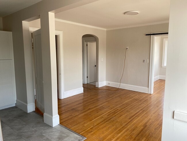 Beautiful hardwood floors and arched entry - 324 E 8th St