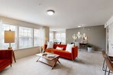 This thoughtfully designed one-bedroom, two-bathroom residence in Temple, Texas, offers a functional and inviting single-floor layout. The open-concept living and dining area is bright and welcoming, featuring plush carpet flooring, multiple windows with blinds that invite abundant natural light, and a seamless flow between the two spaces. The dining area accommodates a round table and benefits from large windows dressed with patterned curtains. The kitchen is outfitted with crisp white shaker cabinetry, dark stone countertops, a subway tile backsplash, wood-look tile flooring, and stainless steel appliances including a side-by-side refrigerator. The spacious primary bedroom offers comfortable carpet flooring, a ceiling fan, and direct access to a well-appointed bathroom featuring white cabinetry with dark countertops and wood-look tile flooring. A dedicated in-unit laundry area with a full-size washer and dryer adds everyday convenience. A second bathroom provides additional functionality for guests. Neutral wall tones and consistent finishes throughout create a cohesive, move-in-ready atmosphere well-suited for comfortable living in central Texas.