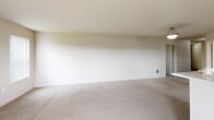 Located at 8060 N Crown Pointe Street in Post Falls, Idaho, this single-story, three-bedroom, two-bathroom home offers a clean and functional layout well-suited for comfortable everyday living. The floor plan flows efficiently, connecting a generous open living area to the rest of the home via a central hallway. The living space features neutral carpet and light-toned walls, creating a bright, versatile canvas. Each of the three bedrooms is carpeted and finished in soft, neutral tones, with natural light streaming in through windows fitted with vertical blinds. The bedrooms each include sliding panel closets, providing practical storage solutions. The spacious primary bedroom offers a notably generous footprint with ample room to furnish comfortably. The two bathrooms are finished with wood-look tile flooring for easy maintenance. The secondary bathroom features a full tub-shower combination and a baseboard heater, while the primary bathroom is appointed with a wide vanity topped with a light countertop, rich dark wood cabinetry, a large mirror, and a stylish multi-bulb light fixture. Throughout the home, six-panel doors and clean white trim contribute to a consistent, tidy aesthetic. The overall ambiance is bright, neutral, and move-in ready.