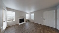 Located at 501 SE 123rd Ave in Vancouver, WA, this single-floor, one-bedroom, one-bathroom home offers a thoughtfully designed layout that maximizes comfort and functionality. The open-concept living and kitchen area serves as the heart of the home, where rich, dark wood-look flooring flows throughout and a ceiling fan adds practical comfort overhead. The living room is bright and welcoming, featuring multiple windows that invite ample natural light and a classic white-mantled fireplace as a standout focal point. The kitchen is well-equipped with light wood cabinetry, a gas range, black refrigerator, track lighting, and a peninsula with a built-in sink — ideal for both everyday cooking and casual dining. A dedicated in-unit laundry closet adjacent to the kitchen adds exceptional convenience. The spacious primary bedroom features plush carpeting, a large window with outdoor views, and a baseboard heater, and connects to a generously sized walk-in closet with dual clothing rods and ample storage. The bathroom is clean and functional, offering a single-sink vanity with cabinet storage and light tile-style flooring. Neutral gray tones throughout the home create a calm, cohesive ambiance well-suited for a variety of décor styles.