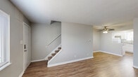Located at 931 Spy Run Rd, this two-story, 2-bedroom, 2-bathroom home offers a clean, well-maintained layout spread across two floors. The main level features an open combined living and dining area with warm wood-look flooring, neutral gray walls, and a textured ceiling. Natural light filters in through windows fitted with blinds, and a ceiling fan adds comfort to the space. A carpeted staircase connects the two floors. The kitchen is equipped with white shaker-style cabinetry, granite-look countertops, a stainless steel sink, and a dishwasher. A utility closet with louvered doors provides in-unit laundry hookups. Both bathrooms feature white vanities with granite countertops, framed mirrors, and wood-look flooring, with one bathroom including a bathtub/shower combo. The bedrooms are generously proportioned, with the primary bedroom offering ample space, wood-look flooring, and a window with outdoor views. The second bedroom also features natural light and the same consistent flooring. Additional storage is available through four closets distributed throughout the home, along with a dedicated utility room. The consistent use of neutral tones and updated finishes throughout creates a cohesive and move-in ready living environment.