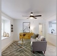 This 750-square-foot, single-floor apartment at 1100 Falls Creek Lane in Charlotte, NC features 2 bedrooms, 2 bathrooms, a living room, laundry, hallway, and 2 closets. The living room is bright and open, anchored by a large picture window that fills the space with natural light and greenery views. Light wood-style flooring, a ceiling fan, and a textured area rug contribute to a clean, contemporary aesthetic throughout. The primary bedroom spans 140 square feet and features a ceiling fan, large window with outdoor views, and light flooring that creates an airy atmosphere. The second bedroom mirrors this welcoming feel with its own ceiling fan, natural light, and a well-proportioned layout. Both bathrooms are finished with marble-style tile surrounds in the tub-shower combinations, light vanities, and wood-tone flooring, offering a clean and polished look. The kitchen connects seamlessly to the main living area, as seen in the floor plan, supporting an open flow ideal for everyday living. Each room reflects a neutral, modern palette with white walls, making the space feel larger and versatile. The unit also includes a dedicated laundry area and ample closet storage, adding practical functionality to this well-appointed Charlotte apartment.