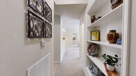 Located in Tulsa, Oklahoma, this well-appointed single-story home offers two bedrooms, two bathrooms, and a functional layout designed for comfortable everyday living. Crown molding is a consistent architectural detail throughout, lending a polished, cohesive feel to each room.

The kitchen is a standout feature, designed in a galley style with dark espresso cabinetry, light countertops, tile flooring, and a full suite of appliances including a refrigerator, range, and dishwasher. It opens directly to the dining area, which is anchored by a pendant chandelier and flows naturally into the living room — an arrangement that supports easy entertaining and daily routines.

The living room receives generous natural light through large windows dressed with layered curtains, and features soft carpet throughout. The primary bedroom is notably spacious, also carpeted, and includes a ceiling fan and ample room for large furnishings. The second bedroom offers similar comfort and natural light.

Both bathrooms are finished with tile flooring and vanities with storage. One bathroom features a soaking tub, while the other includes a shower-tub combination. Each has a linen closet nearby for added convenience.

A dedicated in-unit laundry room with full-size washer and dryer hookups and wire shelving provides practical storage. Two additional closets round out the storage options throughout this well-organized home.