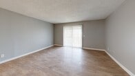 This 690 square foot apartment in Nashville, TN offers a thoughtfully designed living space on a single floor. The property features a modern, open-concept layout that maximizes functionality and flow. The primary bedroom, measuring 190 square feet, provides ample space and includes a window for natural light.

The kitchen is equipped with updated appliances, including a stainless steel refrigerator and a range. Light-colored cabinetry and countertops create a clean, contemporary aesthetic. The adjoining living room offers a spacious area for relaxation and entertainment, with a sliding glass door that likely leads to an outdoor space, enhancing the sense of openness.

Throughout the apartment, wood-look flooring adds warmth and durability. The neutral gray walls provide a versatile backdrop for various decor styles. Modern lighting fixtures, including a stylish ceiling light in the bedroom, contribute to the overall updated feel of the space.

The bathroom features a tub-shower combination with updated fixtures, maintaining the apartment's contemporary theme. A hallway and closet space offer additional storage solutions. The property's cohesive design, with its consistent use of materials and color palette, creates a harmonious and inviting living environment.
