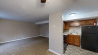 Located at 3111 S Leonard Springs Rd in Bloomington, Indiana, this two-bedroom, one-bathroom single-story home offers a practical and well-organized layout. The living room is generously proportioned, featuring neutral-toned carpet, textured ceilings, and a ceiling fan, creating a comfortable and functional common area. An open sightline connects the living room to the kitchen and dining room, enhancing the sense of flow throughout the space.

The kitchen is efficiently designed with warm honey-toned wood cabinetry extending to the upper walls, light-colored countertops, a stainless steel sink, a gas range, and a full-size black refrigerator. Stone-pattern tile flooring grounds the kitchen and dining area.

Both bedrooms are carpeted and painted in soft, neutral tones with white trim. The primary bedroom includes a built-in shelving unit and a window for natural light. The second bedroom also features a window with exterior views and ample room. Three closets are distributed throughout the home, providing solid storage options.

The bathroom is clean and straightforward, featuring a full tub-shower combo with a white surround, tile flooring, and essential fixtures. A hallway connects the bedrooms and bathroom, completing this efficiently organized home.