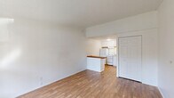 Located at 1310 Aspen Dr in Marysville, Michigan, this one-bedroom, one-bathroom unit offers an efficiently designed single-floor layout. Warm hardwood-style flooring runs throughout the main living areas and bedroom, lending a cohesive and inviting feel to the space.

The living area is bright and open, with white walls, textured ceilings, and a large window that allows natural light to fill the room. A wall-mounted PTAC heating and cooling unit ensures year-round comfort. A panel door leads to the exterior, and the entry area flows naturally into the rest of the unit.

The kitchen is thoughtfully separated from the living area by a half-wall topped with a rich butcher block breakfast bar, which serves as both a functional prep surface and a casual dining spot. Inside, the kitchen features white cabinetry, a white refrigerator, an electric range, and a sink with under-counter storage — all neatly arranged beneath a textured ceiling with built-in lighting.

The spacious bedroom offers ample room for furnishings and includes a dedicated closet with panel doors for convenient storage. The bathroom is clean and straightforward, with a simple, functional design. Throughout the unit, white trim and neutral tones create a clean, move-in-ready aesthetic.