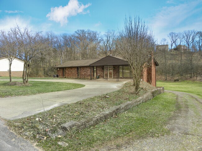 Parking is a breeze with a governer's driveway and wrap-around driveway leading to a 3-car garage. - 6445 Union Ave