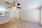 Located at 25469 Borough Park Drive in Spring, TX, this single-floor residence offers four bedrooms and three bathrooms across a well-designed, functional layout. The open-concept living, dining, and kitchen area serves as the heart of the home, finished with light wood-look flooring and neutral tones that create a bright, welcoming atmosphere. Ceiling fans with integrated lighting are featured in the living area, enhancing comfort and airflow. Large windows allow natural light to fill the space throughout the day.

The kitchen is equipped with stainless steel appliances, including a refrigerator, range, and microwave, complemented by light wood cabinetry and a marble-style countertop with a peninsula that connects to the dining and living areas. A pantry and dedicated laundry room add practical storage and utility.

The four bedrooms are thoughtfully arranged along a central hallway. The primary bedroom offers generous proportions, while the additional bedrooms feature plush carpeting and ample closet space, including multiple louvered closet doors. With seven closets total, storage is abundant throughout. The three bathrooms are finished cleanly in white with tub-shower combinations, wood-toned vanities, and wood-look flooring, maintaining a consistent, modern aesthetic throughout the home.