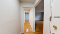 Located at 88 Woodland Rd in the desirable Short Hills neighborhood of New Jersey, Unit 3-2 is a thoughtfully arranged single-floor residence that combines classic charm with practical functionality. Warm-toned hardwood floors run consistently throughout the living areas, hallways, and bedrooms, lending a cohesive and inviting character to the entire space. A central hallway connects the various rooms, providing an efficient and organized flow throughout.

The living area is generously proportioned, featuring large windows that allow natural light to fill the room, complemented by baseboard heating. Multiple bedrooms offer comfortable accommodations, each with hardwood floors, neutral walls, and baseboard heating. Several bedrooms include sliding-door closets with built-in shelving, providing practical storage solutions. Windows in the bedrooms bring in natural light and offer views of the surrounding greenery.

The kitchen is well-equipped with warm wood cabinetry, granite-style countertops, and full-size white appliances including a refrigerator, gas range, and dishwasher. A window above the sink provides natural light and ventilation. The bathroom features white subway tile walling, a vanity with cabinet storage, a mirrored medicine cabinet, and a tiled floor, presenting a clean and functional design throughout.