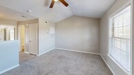 Located at 3430 Broad River Rd in Columbia, SC, this single-floor, one-bedroom, two-bathroom unit offers a practical and well-organized layout across a compact but efficiently designed floor plan. The bedroom is a comfortable size, featuring soft carpet flooring, neutral beige walls, and a vaulted ceiling with a ceiling fan — a standout architectural detail that adds volume and airflow to the space. A sliding glass door opens to a private balcony, bringing in natural light and outdoor views. Two closets provide ample storage throughout the unit. The two bathrooms are clean and functional; one features a white tub-shower combo with a built-in shelf and chrome fixtures, while the other includes a vanity with a white countertop, undermount sink, brushed nickel faucet, and a large wall mirror. The kitchen is equipped with warm oak cabinetry, a white electric range, a full-size refrigerator, a single-basin sink, and wood-look vinyl flooring, offering a practical cooking and prep space. Textured ceilings are present throughout, and the consistent neutral color palette creates a cohesive, understated ambiance across all rooms. The unit is well-suited for single-occupant living or as a starter home in the Columbia, SC area.