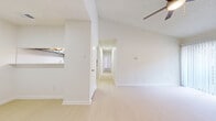 Located in Mesquite, TX, this two-bedroom, one-bathroom single-floor unit offers a clean, bright layout designed for comfortable everyday living. The open living and dining area is highlighted by vaulted ceilings, a ceiling fan with light fixture, and light wood-style flooring that flows throughout the main living spaces, creating an airy and welcoming atmosphere. Large walls with ample vertical space contribute to a sense of openness beyond the unit's footprint.

The kitchen is efficiently arranged with gray cabinetry, white subway tile backsplash, light quartz-style countertops, a stainless steel double-basin sink, an electric range, and a dishwasher. A pass-through shelf connects the kitchen to the adjacent dining area for added convenience.

A hallway leads from the living area to the two bedrooms, both featuring plush carpeting, ceiling fans, and generous closet space. The primary bedroom offers additional room to accommodate larger furniture and provides access to the full bathroom. The bathroom is finished with large-format tile surrounding the tub-shower combo, a white vanity with under-sink storage, and a clean, neutral palette.

With five closets throughout, this unit provides exceptional storage. The bright, neutral interior and practical layout make it a functional and versatile space in the Mesquite, TX area.