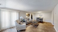 Located at 281 Pinecroft Dr in Taylors, SC, this two-bedroom, one-bathroom single-story home offers a well-designed layout that makes efficient use of its space. The open-concept living and dining area serves as the heart of the home, featuring durable wood-look flooring, neutral gray walls, and a textured ceiling. Large windows and a sliding glass door allow natural light to fill the living room, creating a bright and welcoming atmosphere. The adjacent dining area provides a dedicated space for meals and flows seamlessly into the kitchen. The kitchen is equipped with gray shaker-style cabinetry, granite-look countertops, a gas range, stainless steel sink, and dishwasher, with a window that brings in additional natural light. Both bedrooms are carpeted for comfort. The generously sized primary bedroom features direct access to the full bathroom and a walk-in closet with wire shelving. The second bedroom is well-proportioned with its own closet. The full bathroom includes a gray vanity with a white countertop and a well-lit mirror. A hallway connects the main living areas to the bedrooms, completing the functional single-floor layout of this Taylors, SC residence.
