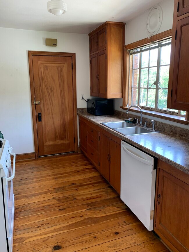 Kitchen with handbuilt cabinets and hardwood floors. - 555 56th St