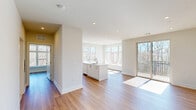 Located at 434 Springfield Ave in Berkeley Heights, NJ, this thoughtfully designed residence offers four bedrooms and two bathrooms across a single floor. The open-concept living and kitchen area serves as the heart of the home, featuring warm hardwood flooring, recessed lighting, and large windows that flood the space with natural light. A central kitchen island with a quartz countertop and an integrated sink anchors the kitchen, which is complemented by a stainless steel range, sleek white lower cabinetry, and warm wood-toned upper cabinets. Sliding glass doors open to a private balcony with outdoor views of surrounding greenery. A clean, bright hallway connects the bedrooms, each finished with the same hardwood flooring and neutral-toned walls. The spacious primary bedroom offers generous proportions and ample closet space. Both bathrooms are elegantly appointed with marble-style tile walls and floors, hexagonal mosaic floor tile, frameless mirrors, and modern white floating vanities, delivering a refined and cohesive aesthetic. The overall ambiance is fresh, contemporary, and move-in ready.