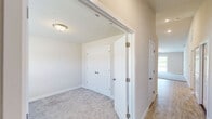 Located at 9250 Earlmont Dr in Fort Wayne, Indiana, this single-floor, 2-bedroom, 1-bathroom home offers a well-organized layout with a comfortable, functional design throughout. The combined kitchen and living area forms the heart of the home. The living room features soft carpeting, vaulted ceilings, a ceiling fan with light, and a sliding glass door that fills the space with natural light and opens to outdoor views. The kitchen is appointed with warm honey-toned cabinetry, light granite-style countertops, stainless steel appliances including a refrigerator and range, tile-style flooring, and a peninsula with a double sink — ideal for both cooking and casual dining. The primary bedroom is generously sized, with plush carpeting and a dedicated walk-in closet outfitted with wire shelving and hanging rods for ample storage. The second bedroom also features carpet flooring and a window with natural light. The shared bathroom includes a wood-toned vanity with an integrated sink, a large mirror, and tile-style flooring. Clean neutral tones, white panel doors, and consistent finishes throughout lend the home a cohesive and move-in-ready appearance.