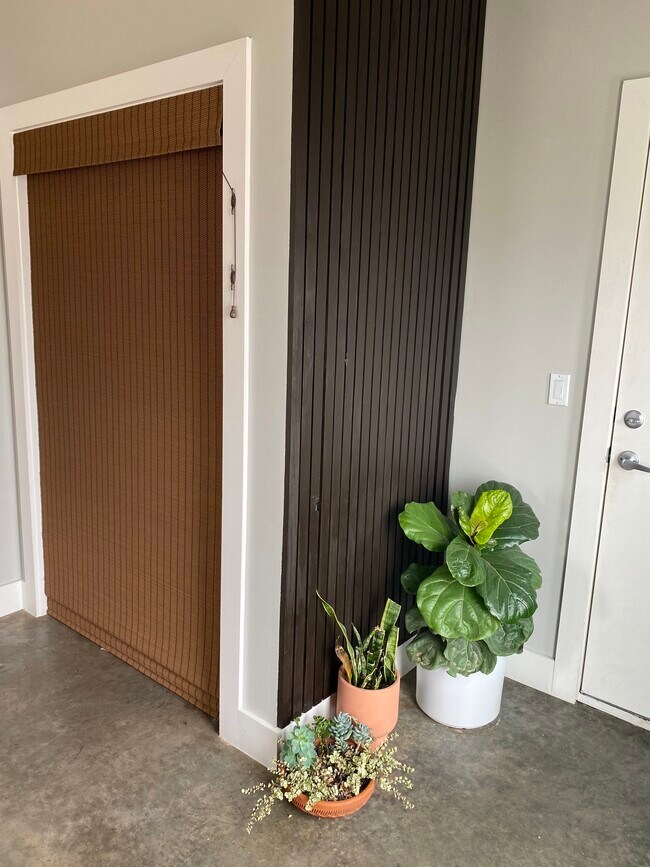 Laundry area from front door view (garage to right, DIY batten wall and bamboo blinds come included) - 1432 S Trenton Ave