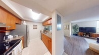 Located at 6730 Bull Run Road in Hialeah, FL, this single-floor, 2-bedroom, 2-bathroom residence offers a thoughtfully designed layout that maximizes functionality. The galley-style kitchen is outfitted with warm wood cabinetry, granite-style countertops, stainless steel appliances including a refrigerator and electric range, and tile flooring — providing ample storage and counter space for everyday cooking. An electrical panel is conveniently integrated into the kitchen area.

The open living and dining area flows naturally together, featuring smooth wood-look flooring, large windows that invite abundant natural light, and sliding glass doors dressed with floor-to-ceiling curtains. This bright, airy space creates a comfortable environment for both relaxing and entertaining.

The generously sized primary bedroom is carpeted and includes sliding glass doors that open to an outdoor balcony, offering views of the surrounding greenery. It is complemented by a walk-in closet with built-in wire shelving. The second bedroom is also carpeted and features its own closet with dedicated shelving. Both bathrooms are finished with tile flooring, wood vanity cabinetry, and mirrored medicine cabinets. The textured ceilings are consistent throughout, lending a cohesive finish to the entire residence.