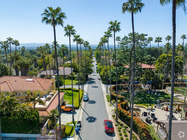Palm trees line the sunny residential streets in Altadena, CA.