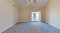 Located at 1500 Lewis Turner Blvd. in Fort Walton Beach, FL, this two-story home offers three bedrooms, two full bathrooms, and a well-designed layout spread across two floors. The main level forms the heart of the home, featuring a combined kitchen and living area. The kitchen is equipped with warm maple cabinetry, granite-style countertops, a subway tile backsplash, black appliances including a range, dishwasher, and refrigerator, and tile flooring. A pass-through counter opens directly to the living area, creating an open, connected feel. The bedrooms are carpeted and feature ceiling fans and natural light from windows. The spacious primary bedroom includes a ceiling fan and sliding glass doors that open to a private balcony, offering outdoor access and added natural light. The two bathrooms are finished with tile flooring, warm-toned walls, and wood-accented vanities; one features a full tub-shower combo. A dedicated laundry room with washer and dryer hookups adds everyday convenience. The upper floor provides additional flexible living space. Throughout the home, warm neutral tones and consistent finishes create a cohesive and comfortable ambiance.