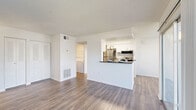 Located at 100 Reflections Circle in Casselberry, FL, this single-story one-bedroom, one-bathroom residence offers a well-designed layout that maximizes comfort and functionality. The open-concept living and dining area is anchored by durable wood-style flooring and crisp white walls, creating a bright, clean aesthetic. A sliding glass door floods the space with natural light and provides direct outdoor access. The kitchen features a peninsula-style breakfast bar with a dark countertop, white cabinetry, stainless steel appliances including a refrigerator, microwave, and range, and a skylight that adds extra brightness to the workspace. A dedicated in-unit laundry area with a full-size washer and dryer adds everyday convenience. The bedroom is a comfortable retreat with plush carpeting, a natural light window with blinds, and a closet with wire shelving. The bathroom is appointed with a single-sink vanity, dark countertop, a large mirror, and a tub-shower combination. Textured ceilings are consistent throughout the home, complementing the overall clean and neutral palette. This thoughtfully arranged residence offers a practical and inviting living experience in a central Florida location.