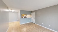 Located at 301 SE 6th Ave in Homestead, FL, this single-story, 2-bedroom, 1-bathroom home offers a practical and well-organized layout. Consistent light-toned ceramic tile flooring and neutral gray walls run throughout, creating a clean and cohesive aesthetic. Textured ceilings add a classic touch to each room.

The combined kitchen and living area forms the heart of the home. The kitchen features warm wood cabinetry, a stainless steel refrigerator, an electric range, and a striking marble-look countertop that doubles as a pass-through to the living space. The living room is bright and open, with a sliding glass door fitted with vertical blinds that provides access to the outdoors and allows natural light to fill the space.

Both bedrooms are comfortably sized with large windows that invite additional natural light and offer views of the surrounding greenery. The primary bedroom includes a built-in closet with louvered bifold doors, providing practical storage. The second bedroom is bright and versatile.

The bathroom is finished with a full tub-and-shower combination, chrome fixtures, and a clean white surround. A dedicated closet elsewhere in the unit adds further storage utility. The overall layout is efficient, making excellent use of the available space throughout.