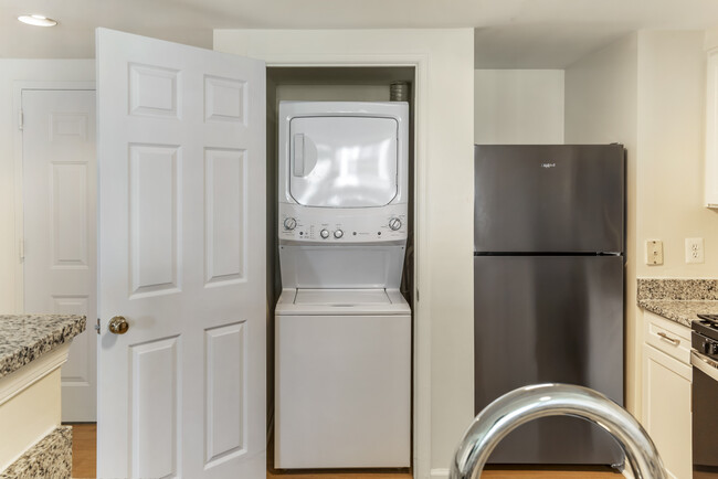 Renovated Package I kitchen with in-unit laundry - Avalon Courthouse Place