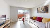 Located in Glendale, Arizona, this efficiently designed one-bedroom, one-bathroom residence offers a well-organized single-floor layout that maximizes every square foot. The combined living and dining area is bright and welcoming, featuring light wood-style flooring, a textured ceiling, and a large sliding glass door that opens onto a private patio — flooding the space with natural Arizona sunlight and providing a seamless indoor-outdoor connection. The patio offers a quiet retreat with room for outdoor seating.

The galley-style kitchen is thoughtfully appointed with white cabinetry, quartz-style countertops, a grey subway tile backsplash, and a full suite of stainless steel appliances including a range, refrigerator, and dishwasher. A dedicated dining nook adjacent to the kitchen provides a functional space for everyday meals.

The bedroom is a comfortable and carpeted retreat, featuring multiple windows with shutters that allow for natural light and privacy control, along with a dedicated closet for storage. A hallway connects the main living areas to the bathroom, which features wood-style flooring consistent with the rest of the home. Throughout, the neutral color palette and clean finishes create a calm, move-in-ready atmosphere.