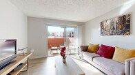 Located in Glendale, Arizona, this efficiently designed one-bedroom, one-bathroom residence offers a well-organized single-floor layout that maximizes every square foot. The combined living and dining area is bright and welcoming, featuring light wood-style flooring, a textured ceiling, and a large sliding glass door that opens onto a private patio — flooding the space with natural Arizona sunlight and providing a seamless indoor-outdoor connection. The patio offers a quiet retreat with room for outdoor seating.

The galley-style kitchen is thoughtfully appointed with white cabinetry, quartz-style countertops, a grey subway tile backsplash, and a full suite of stainless steel appliances including a range, refrigerator, and dishwasher. A dedicated dining nook adjacent to the kitchen provides a functional space for everyday meals.

The bedroom is a comfortable and carpeted retreat, featuring multiple windows with shutters that allow for natural light and privacy control, along with a dedicated closet for storage. A hallway connects the main living areas to the bathroom, which features wood-style flooring consistent with the rest of the home. Throughout, the neutral color palette and clean finishes create a calm, move-in-ready atmosphere.