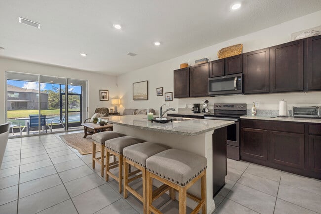Kitchen, living room, back patio and bar - 8995 Milestone Dr