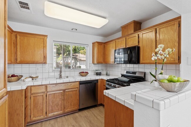 Open Kitchen with stainless steel appliances - 3682 Whispering Creek Cir