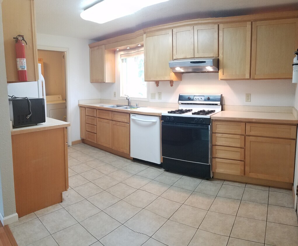 Spacious kitchen, pull-out multi-spray kitchen faucet, lots of stage space, over sink lighting, ample range lighting for cooking, dish washer, utility/laundry room with door. - 5301 E 30th Ave