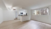 Located at 6600 Woodley Ave in Los Angeles, CA, this two-bedroom, two-bathroom residence offers a clean, modern aesthetic throughout its single-floor layout. The open-concept living area flows seamlessly into the dining space, featuring light wood-style flooring and a ceiling fan that enhances the bright, airy atmosphere. Large windows frame views of lush greenery, filling the space with natural light.

The kitchen is thoughtfully designed with white cabinetry, granite-style countertops, stainless steel appliances including a gas range, microwave, and dishwasher, and a peninsula that doubles as a breakfast bar—ideal for casual dining or meal prep. The layout connects effortlessly to the living and dining areas, making it well-suited for everyday living and entertaining.

Both bedrooms are carpeted for comfort and feature mirrored sliding closet doors that add depth and reflect natural light. The primary bedroom includes its own ceiling fan and ample closet space. Three closets throughout the unit provide generous storage.

The two bathrooms are finished in a crisp, all-white palette with tub-shower combinations and light wood-style flooring, maintaining the home's clean and cohesive design. The overall ambiance is bright, functional, and move-in ready.