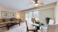 Located at 27367 Detroit Rd in Westlake, Ohio, this one-bedroom, one-bathroom residence offers a thoughtfully laid-out single-floor plan. The combined living and dining area serves as the heart of the home, featuring plush wall-to-wall carpeting, a textured ceiling with a ceiling fan, and a large sliding glass door dressed with vertical blinds that floods the space with natural light and provides views of the outdoor area. The dining space is defined by wainscoting along the walls, adding a classic architectural touch.

The kitchen is functionally designed with warm oak cabinetry, granite-toned laminate countertops, a stainless steel sink, and white appliances including a refrigerator and dishwasher, set on durable tile flooring. A connecting hallway leads seamlessly to the private bedroom, which is generously sized with soft carpeting, a textured ceiling, and a window with blinds that invites natural light.

The full bathroom features tile flooring, a vanity with wood cabinetry, and a shower-tub combination. Throughout the residence, neutral tones and consistent finishes create a cohesive, comfortable ambiance well-suited for everyday living in the Westlake community.