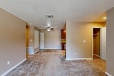 Located at 10741 Fair Oaks Blvd in Fair Oaks, CA, this single-floor, 2-bedroom, 2-bathroom residence offers a functional and comfortable layout. The open living area is finished with plush carpeting and neutral warm-toned walls, creating a welcoming atmosphere. A ceiling fan adds convenience, while a sliding glass door allows natural light to filter in and provides outdoor access.

The kitchen is a standout feature, showcasing rich dark wood cabinetry, granite-style countertops, and a full suite of stainless steel appliances including a gas range, dishwasher, and refrigerator. Light wood-style flooring grounds the space and transitions seamlessly from the kitchen into the adjoining areas.

The spacious primary bedroom features a large window framing views of mature trees, filling the room with natural light. A dedicated walk-in closet with wrap-around shelving and hanging rods provides generous storage. Both bathrooms are clean and functional, with light wood flooring, and one includes a full shower/tub combination. A stacked in-unit laundry area adds everyday convenience. Throughout the home, textured ceilings and clean white trim provide a cohesive, well-maintained finish.