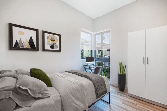 Private bedroom w/ full bed, desk, office chair, closet, ensuite bathroom - Plum Apartments