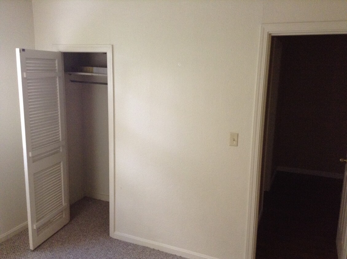 Second bedroom with smaller closet to the left and hallway to the right. The bathroom is behind the closet. - 24 N K St