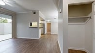 Located at 5059 Quail Run Rd in Riverside, California, this single-floor residence offers a well-designed layout with a clean, modern aesthetic throughout. The open living area is finished with warm wood-style flooring and accented by crown molding, creating a polished and inviting atmosphere. A ceiling fan overhead and sliding glass doors leading to a private patio enhance the living space, allowing natural light to flow in and providing convenient outdoor access.

The kitchen is thoughtfully appointed with white cabinetry, quartz-style countertops, and stainless steel appliances, including a range, microwave, and refrigerator. A pass-through window connects the kitchen to the living area, adding an open and functional touch. Wood-style flooring continues throughout the kitchen, which also benefits from natural light through a vertical-blind window.

The bedrooms are carpeted for comfort and each feature ceiling fans, vertical-blind windows, and generous closet space, including walk-in and mirrored sliding-door closets. The bathroom is clean and functional, offering a full tub-shower combination, a vanity with mirror, and wood-style flooring. Additional storage and closet space are accessible near the entryway, rounding out this practical and well-maintained residence.