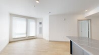 Located at 1110 W Columbia Way in Vancouver, WA, this modern single-floor residence offers three bedrooms, one bathroom, and a thoughtfully designed layout that maximizes every square foot. Light wood-tone flooring runs throughout the home, creating a warm, cohesive aesthetic against crisp white walls and clean-lined architecture.

The kitchen is a standout feature, showcasing dark gray flat-front cabinetry, quartz countertops with a subtle veining pattern, a central island, a tile backsplash, and a full suite of stainless steel appliances including a refrigerator, range, microwave, and dishwasher. Recessed lighting and under-cabinet illumination enhance the modern feel.

The open living area flows naturally from the kitchen, bathed in natural light from large windows dressed with roller shades. The spacious primary bedroom offers a comfortable footprint with a bright window, while the two additional bedrooms provide flexibility for various living arrangements.

The bathroom is finished with a dark-tiled tub and shower surround, a sleek vanity with dark cabinetry and brushed gold hardware, and light wood flooring that ties back to the rest of the home. A central hallway connects all rooms efficiently, contributing to the unit's clean, functional design.