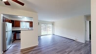 Located at 906 Joliet Rd in La Grange Highlands, IL, this 2-bedroom, 1-bathroom residence offers a practical and comfortable single-floor layout. The open-concept living and dining area is bright and inviting, featuring durable hardwood-style plank flooring and a large sliding glass door that frames lush outdoor greenery and fills the space with natural light. The door provides direct access to a private patio, extending the living space outdoors.

The kitchen is thoughtfully designed with rich cherry-toned cabinetry, dark granite countertops, a stainless steel dishwasher, and a window above the sink that brings in additional natural light. A pass-through connects the kitchen to the living and dining area, enhancing the open feel.

Both bedrooms are carpeted for comfort and feature closets and windows that allow natural light to filter in. The generously sized primary bedroom offers ample space for furnishings. The full bathroom is well-appointed with a tiled tub-shower combination, a vanity with matching cabinetry and granite countertop, and hardwood-style flooring. Throughout the residence, clean white walls and neutral tones create a bright, cohesive aesthetic.